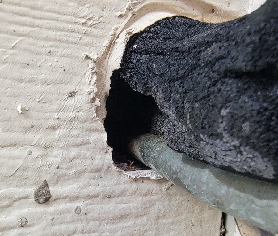 AC hose entering the home, sealed against pests