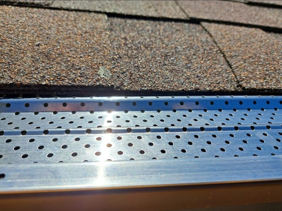 Gutter guard mesh installed along a gutter